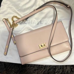 Light pink wallet or side bag .